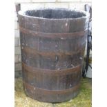 A coppered barrel form garden planter.