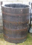 A coppered barrel form garden planter.