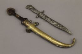 An Eastern jambiya and another dagger. The former 40 cm long.
