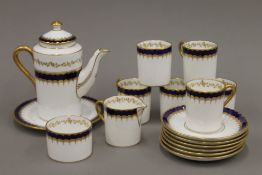 A Coalport gilt heightened blue and white coffee set.