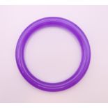 A lavender jade bangle. 6 cm internal diameter.