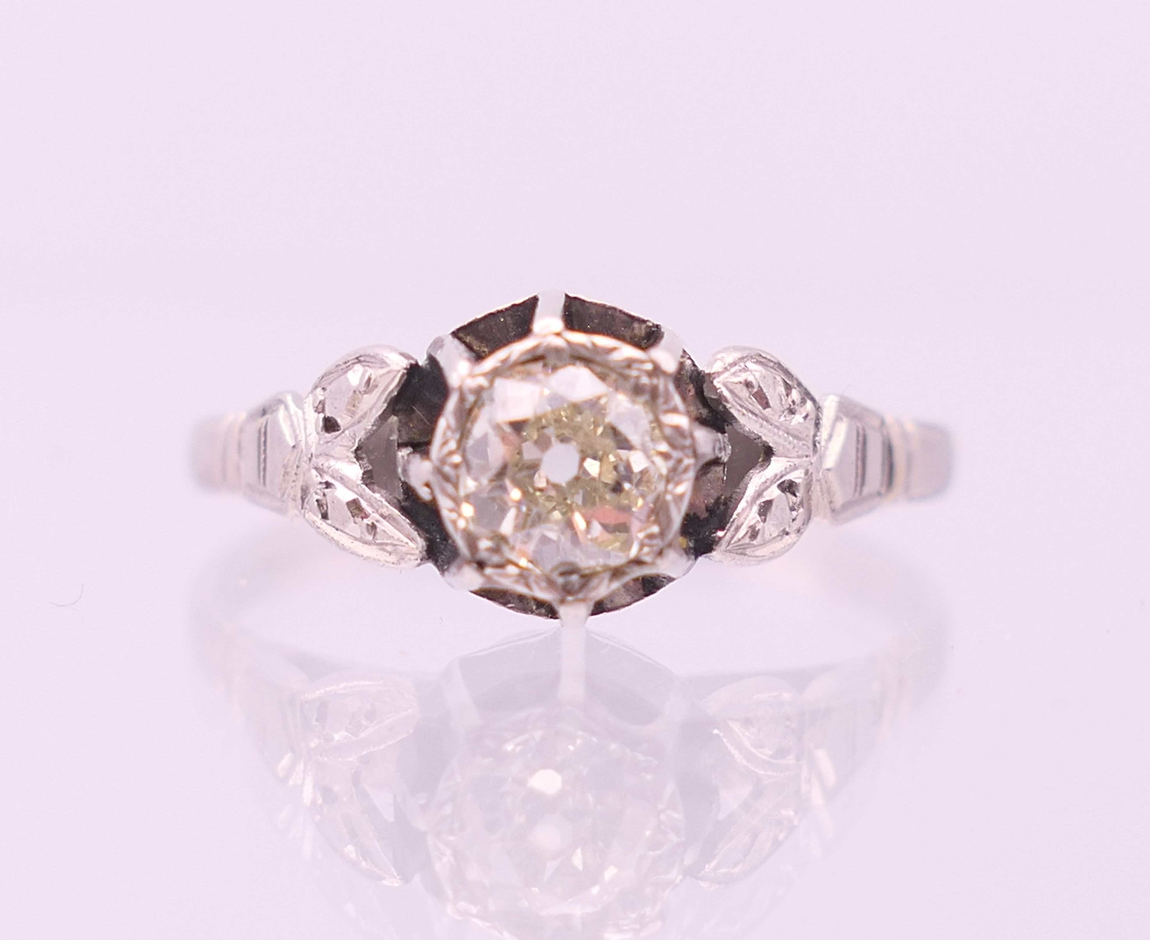 An 18 ct white gold and platinum diamond solitaire ring. The central approximately .5 carat.