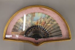 A Spanish hand coloured fan in a bespoke gilt display case. The case 62 cm wide.