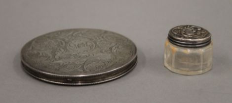 A silver compact and a small silver topped jar. The former 8.25 cm diameter.