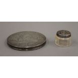 A silver compact and a small silver topped jar. The former 8.25 cm diameter.