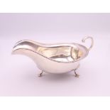 A silver sauceboat. 6.5 cm high x 15 cm long. 103.8 grammes.