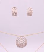 A pair of 9 ct gold and diamond earrings and a matching pendant necklace. Earrings 1.