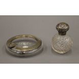 A silver mounted ash tray and a silver topped scent bottle. The former 11.5 cm diameter.