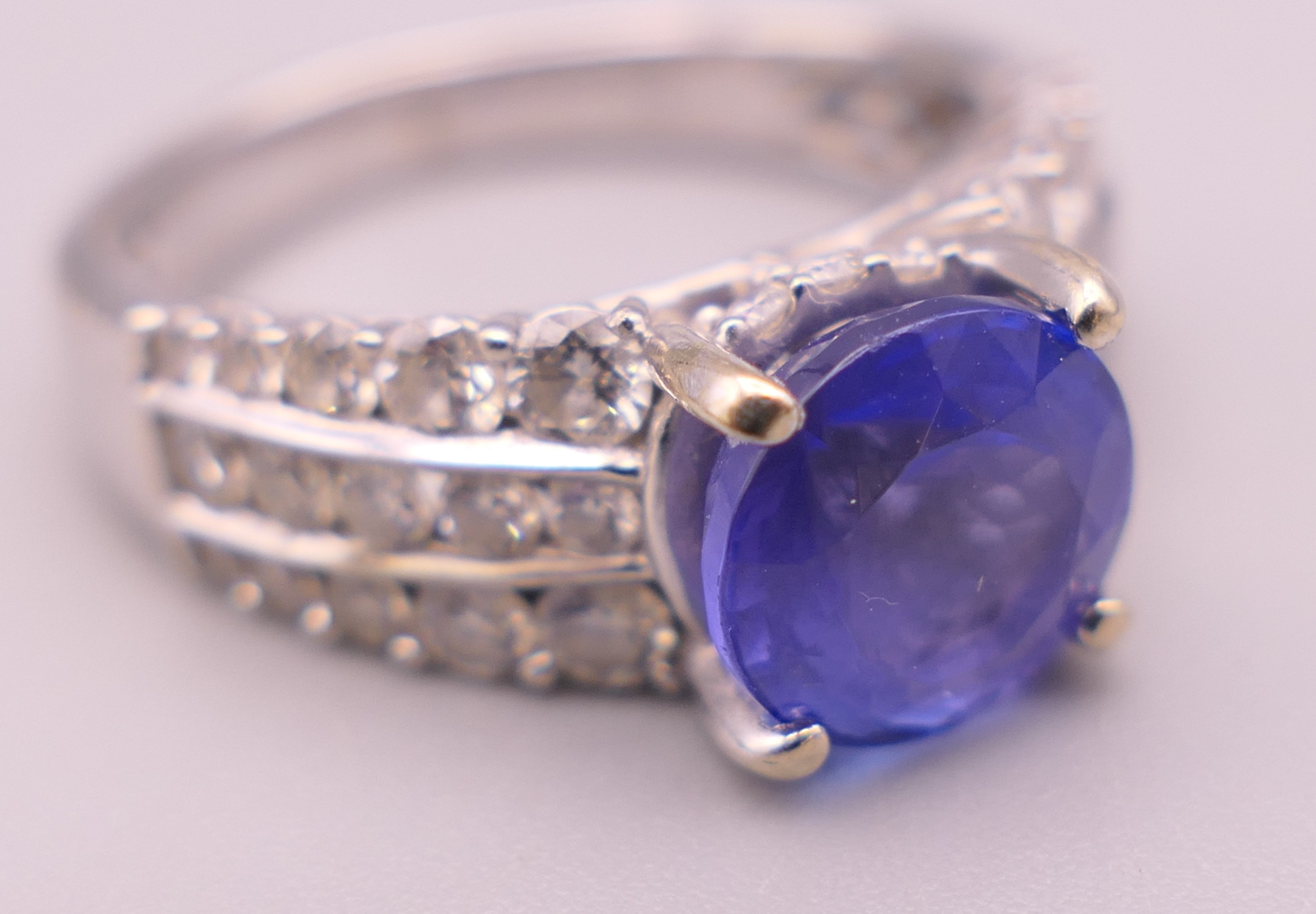 An 18 K white gold diamond and tanzanite ring; - Image 6 of 6