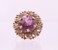 A 9 ct gold, amethyst and diamond flowerhead ring. Ring size Q.