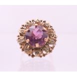 A 9 ct gold, amethyst and diamond flowerhead ring. Ring size Q.