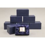 A set of eight silver napkin rings, in boxes. Approximately 128 grammes.