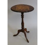 A Victorian inlaid walnut games table. 45 cm diameter.