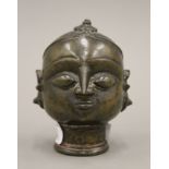 An antique Eastern bronze bust. 10 cm high.