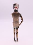 A silver and enamel peg doll form pepperette, inscribed Frank Hyams Ltd, 128 New Bond St, W. 10.