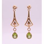 A pair of 9 ct gold and peridot drop earrings. 4 cm high. 4.9 grammes total weight.