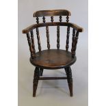 A Victorian child's smokers bow armchair. 36.5 cm wide.