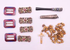 A box of various enamel decorated buckles, cheroot holders, etc.