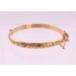 A gold plated Christening bangle. 4.5 cm diameter.
