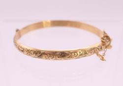 A gold plated Christening bangle. 4.5 cm diameter.