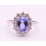 An 18 ct white gold sapphire and diamond ring. The sapphire approximately 1 carat. Ring size N.