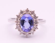 An 18 ct white gold sapphire and diamond ring. The sapphire approximately 1 carat. Ring size N.