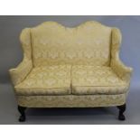 An early 20th century upholstered double camel back settee. 143 cm wide.