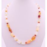 A rough cut opal and gold mounted necklace. 48 cm long.