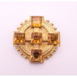 A Victorian unmarked high carat gold citrine set Celtic revival brooch. 2.5 cm diameter. 6.