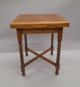 A small early 20th century oak barley twist drawer leaf table. 61.5 x 60 cm closed.