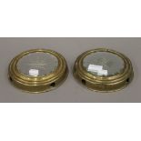 A pair of brass framed sorcerer's mirrors. 17.5 cm diameter.