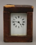A brass carriage clock, with key, in original carrying case. The case 12.5 cm high .