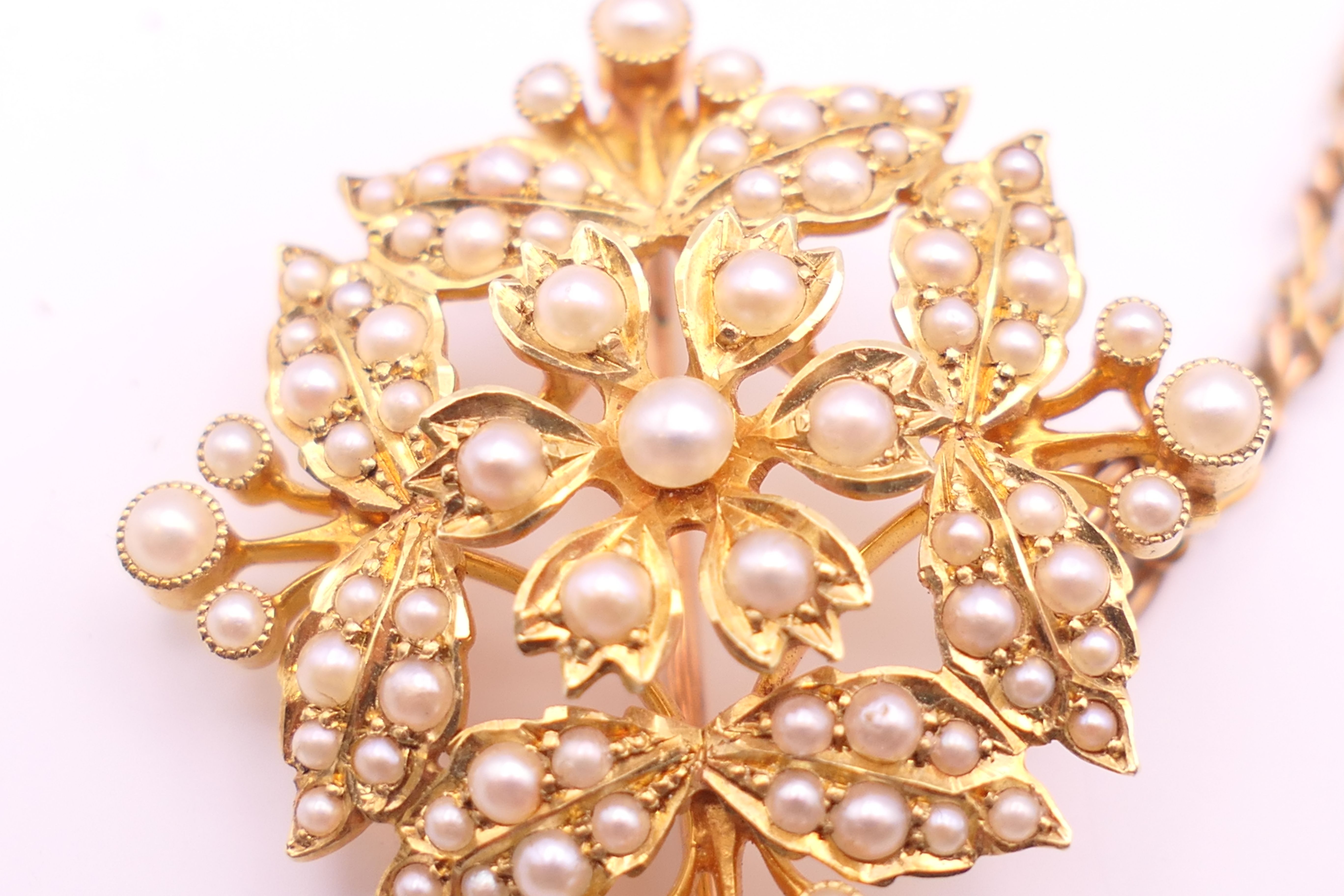 A 15 ct gold and seed pearl pendant/brooch on a 9 ct gold chain. - Image 4 of 9