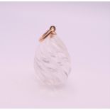 A 14 ct gold mounted rock crystal egg pendant. 2 cm high excluding suspension loop.