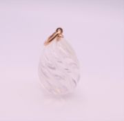 A 14 ct gold mounted rock crystal egg pendant. 2 cm high excluding suspension loop.