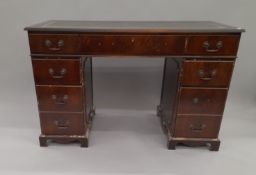 A reproduction mahogany pedestal desk. 120 cm wide.