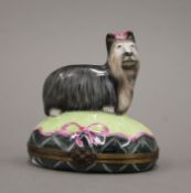A Limoges porcelain box, the top set with a dog. 8.5 cm high.