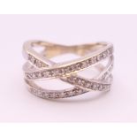 A white gold and diamond crossover ring. Ring size S.