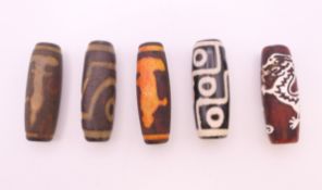 Five agate dzi beads. Each approximately 4 cm high.