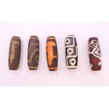 Five agate dzi beads. Each approximately 4 cm high.