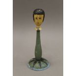 An early 20th century painted wooden display stand of female figural form. 25 cm high.