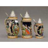 Three pottery lidded steins. The largest 23 cm high.