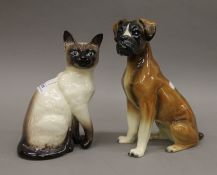 A Beswick Siamese cat and a model of a boxer dog. The former 24 cm high.
