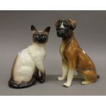 A Beswick Siamese cat and a model of a boxer dog. The former 24 cm high.