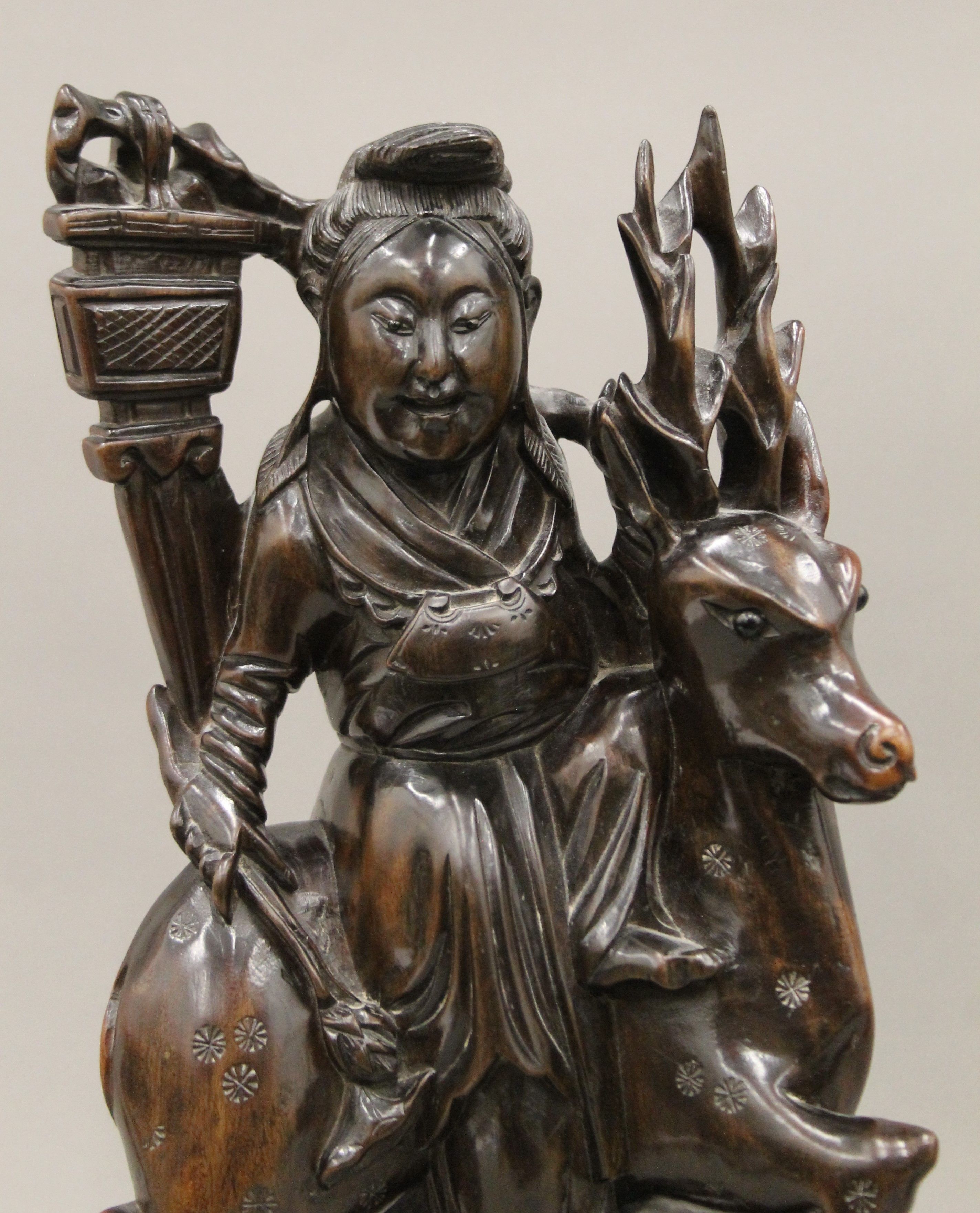 A pair of late 19th/early 20th century Chinese hardwood carvings depicting Guanyin riding a deer. - Image 3 of 4