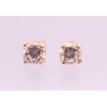A pair of 18 ct gold diamond stud earrings. Total diamond weight approximately .36 carat.