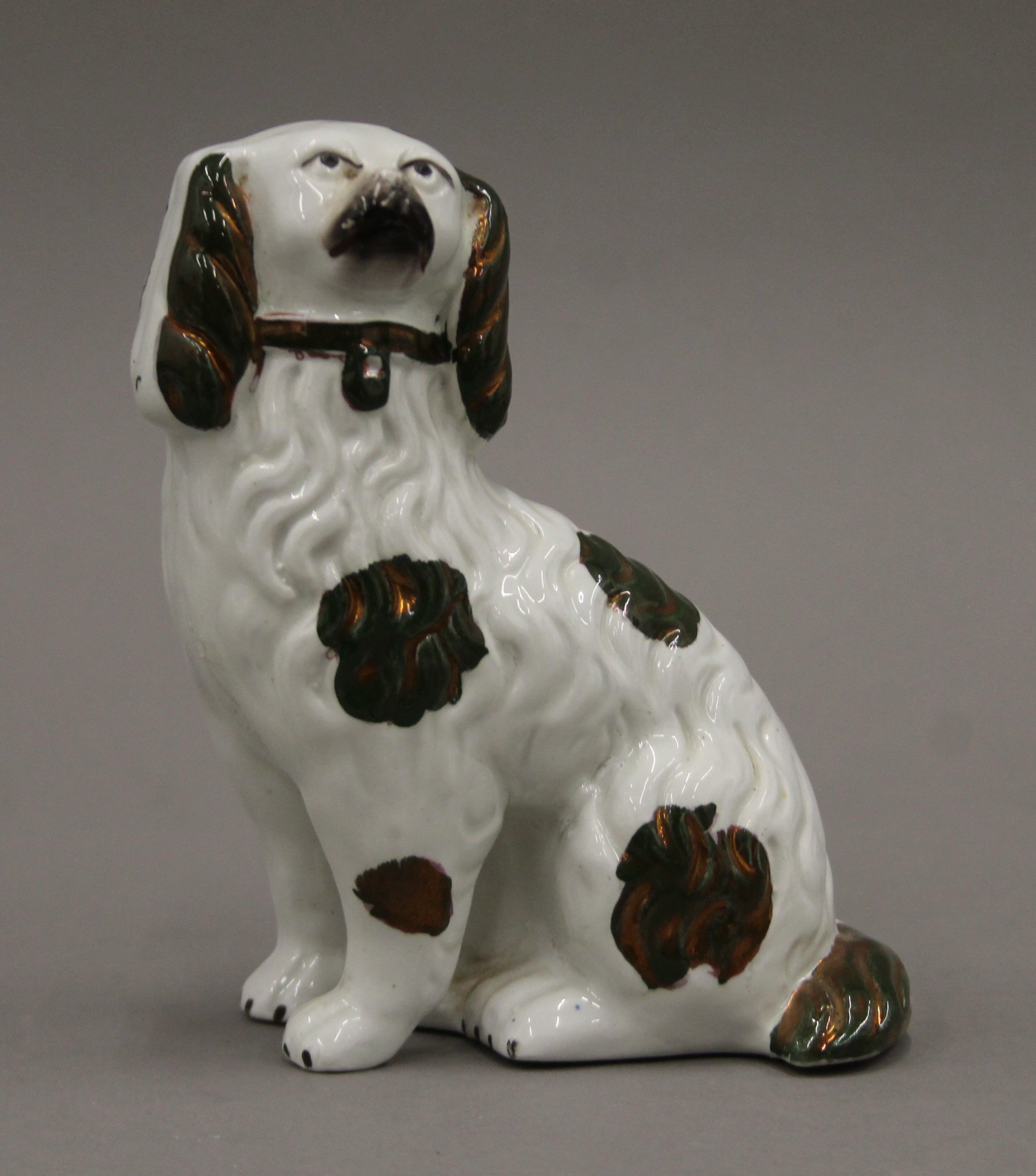 A pair of Victorian Staffordshire spaniels with green and copper lustre decoration. 14 cm high. - Image 2 of 4