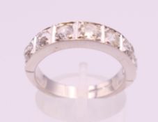 A platinum and diamond half hoop eternity ring. Total diamond weight approximately 1.75 carat.