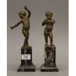 A pair of bronze putto, on marble bases. The largest 27 cm high.
