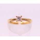 An 18 ct gold solitaire diamond ring. Ring size I. 2.6 grammes total weight.